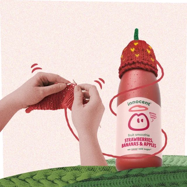 knitting a strawberry hat on a innocent smoothie bottle for the big knit